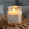 Candle burning in a glass jar